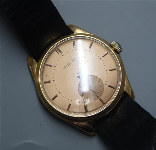 A gentlemans 18k yellow metal Lemania manual wind wristwatch with subsidiary seconds, on associated strap.